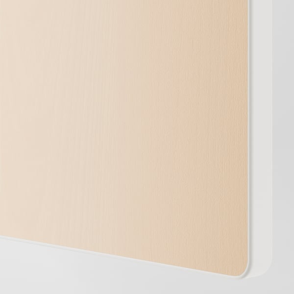 A close-up of a smooth, light-colored wooden surface with a white edge, part of a drawer front from the SMÅSTAD collection.