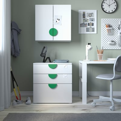 Childrens room with white & green SMÅSTAD furniture, cabinet, desk, chair, clock, and toy.