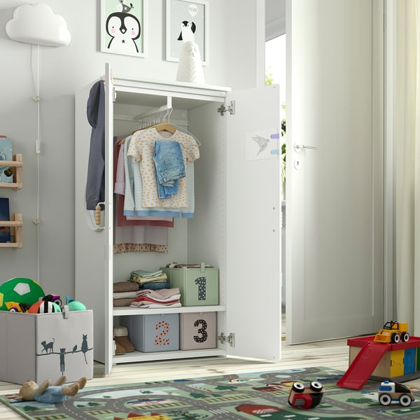 Kids wardrobe with low-hanging clothes, adjustable shelves, and storage boxes, promoting independence and organisation.