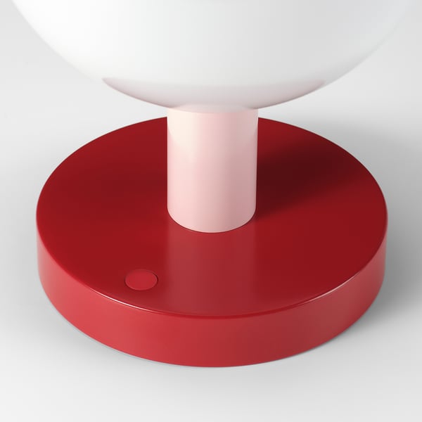 Modern table lamp with red base, pink tube, white shade. Minimalist design, high-quality materials.