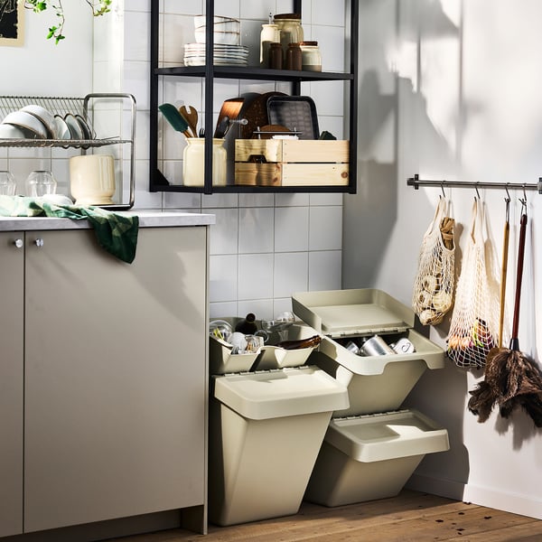 Modern kitchen with grey cabinet and SORTERA waste sorting system under shelves.