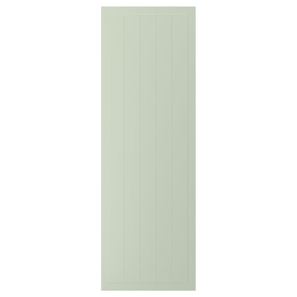 A green STENSUND cabinet door with vertical grooves, made of fibreboard and lacquered for easy cleaning.