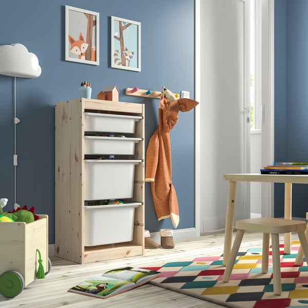 Kids room featuring TROFAST light pine storage unit with white boxes. Bright rug, colourful toys, and simple decor.
