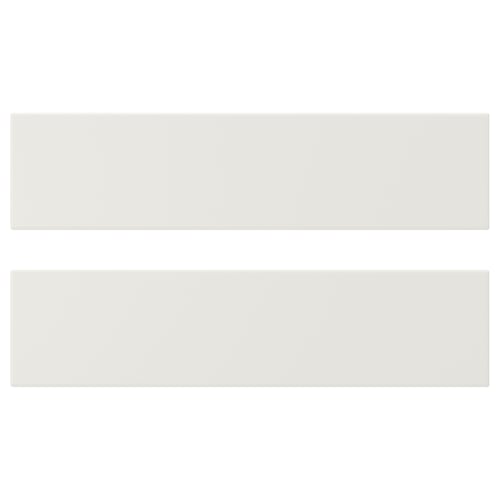 White VEDDINGE kitchen cabinets, sleek and modern. Made from fibreboard and polyurethane paint, rectangular shape.