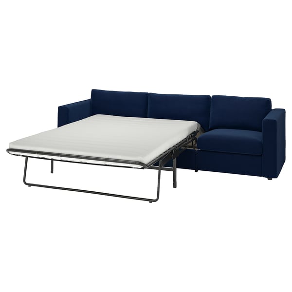 Blue sofa bed shown with white mattress, modern design. Pop-up mechanism for extra seating.