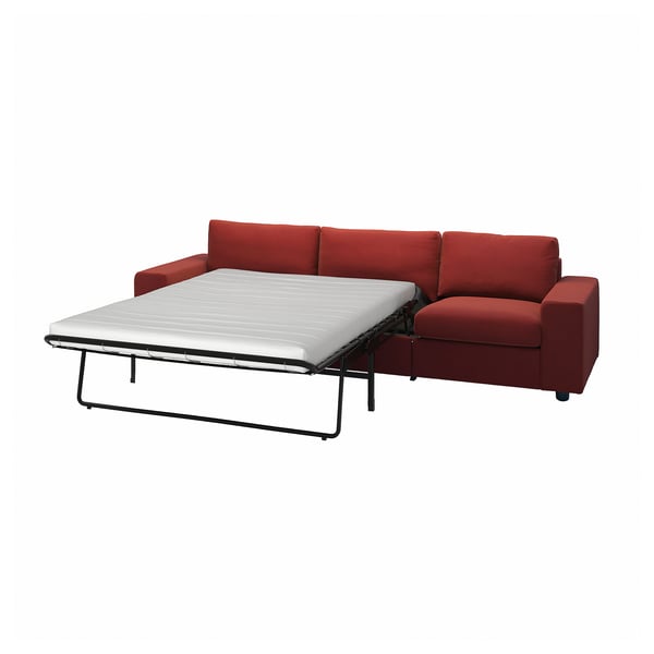 Red convertible sofa with white mattress, modern design, upholstered in recycled fabric, practical for small spaces.
