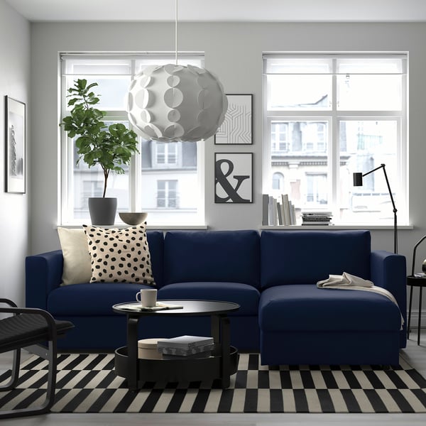 Modern living room with blue VIMLE sectional sofa, city view.