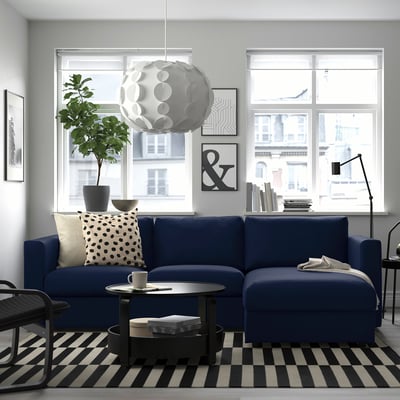 Modern living room with blue VIMLE sectional sofa, city view.