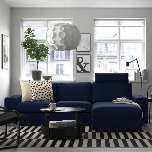 Modern living room with blue VIMLE sectional, city views, and striped rug.