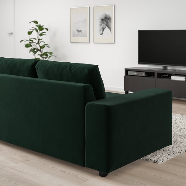 Elegant green VIMLE sofa with chaise, velvet cover, and modern design stands out in living room.
