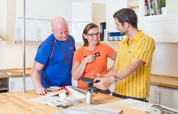 2 customers are discussing with an IKEA employee