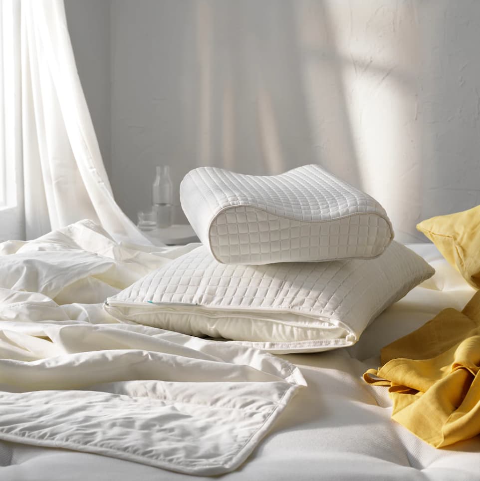 2 Pillows on a bed by the window