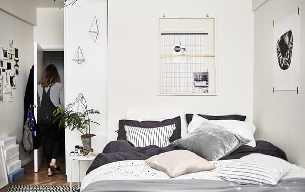 A bedroom decorated in black, white and grey.