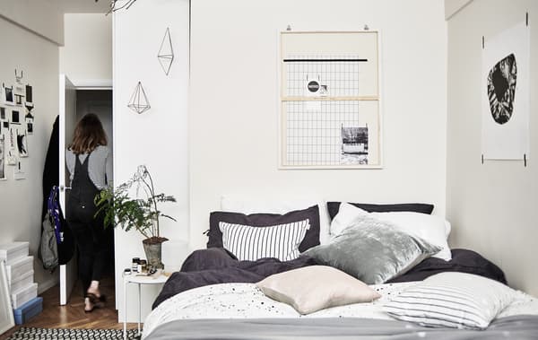 A bedroom decorated in black, white and grey.