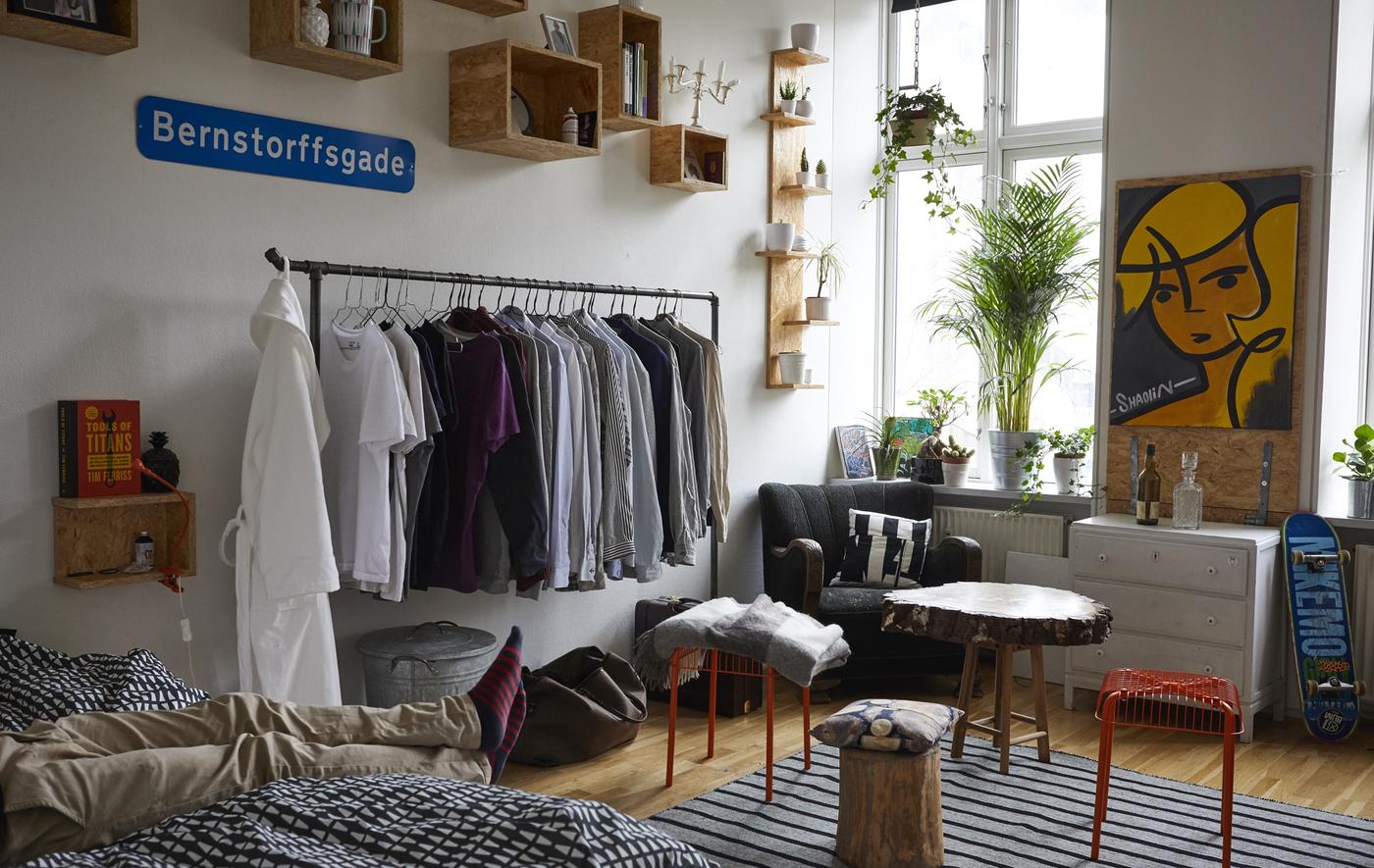 A bedroom with bed, coffee table and open storage.