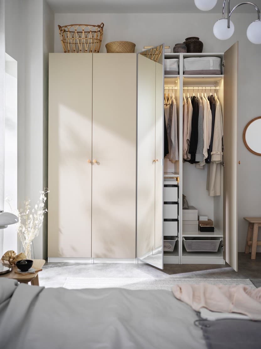 A bedroom with wardrobes, bed and bedside table.
