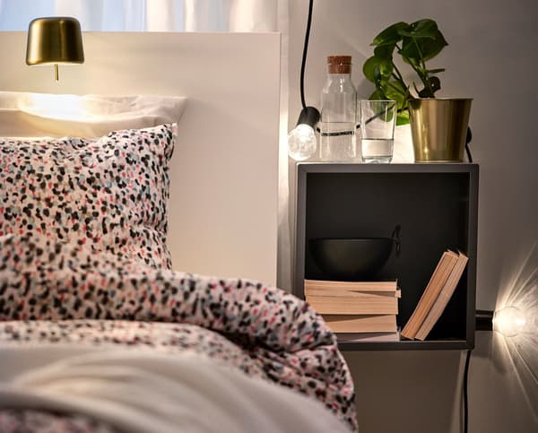 A bedside table with task lighting.
