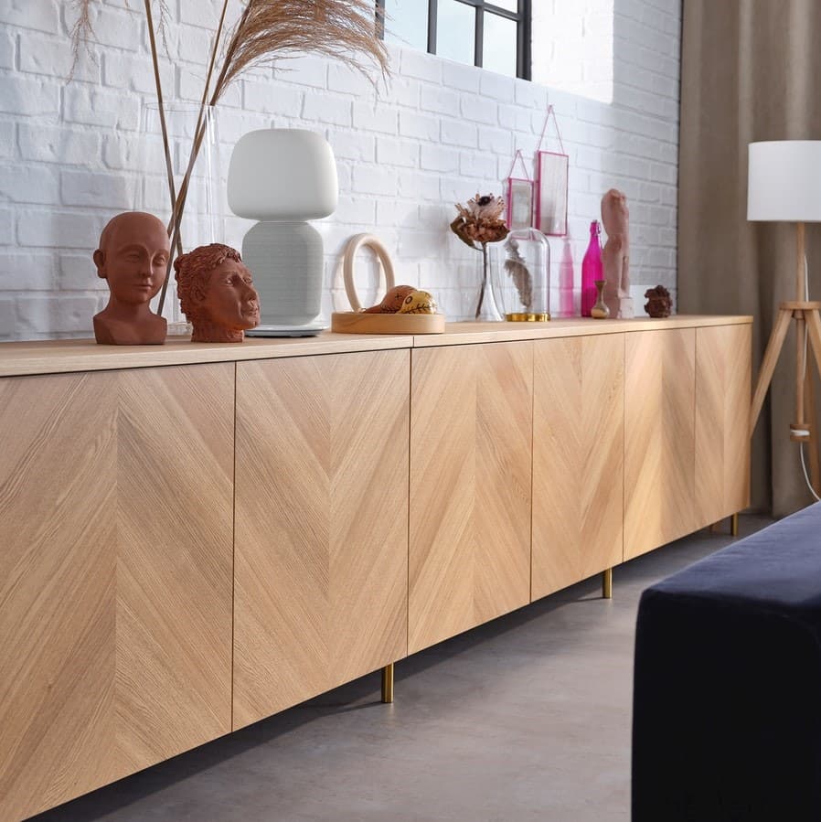 A BESTÅ and HEDEVIKEN oak veneer sideboard combination with vases and decorations in the living room.