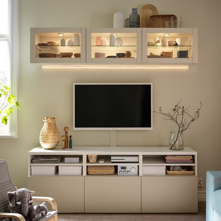 A BESTÅ and HEDEVIKEN oak veneer sideboard combination with vases and decorations in the living room.