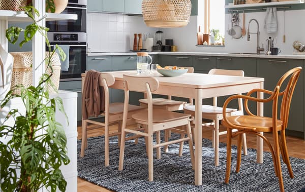A birch wood dinner table and four chairs from the RÖNNINGE series, plus an IKEA chair from the 60’s.