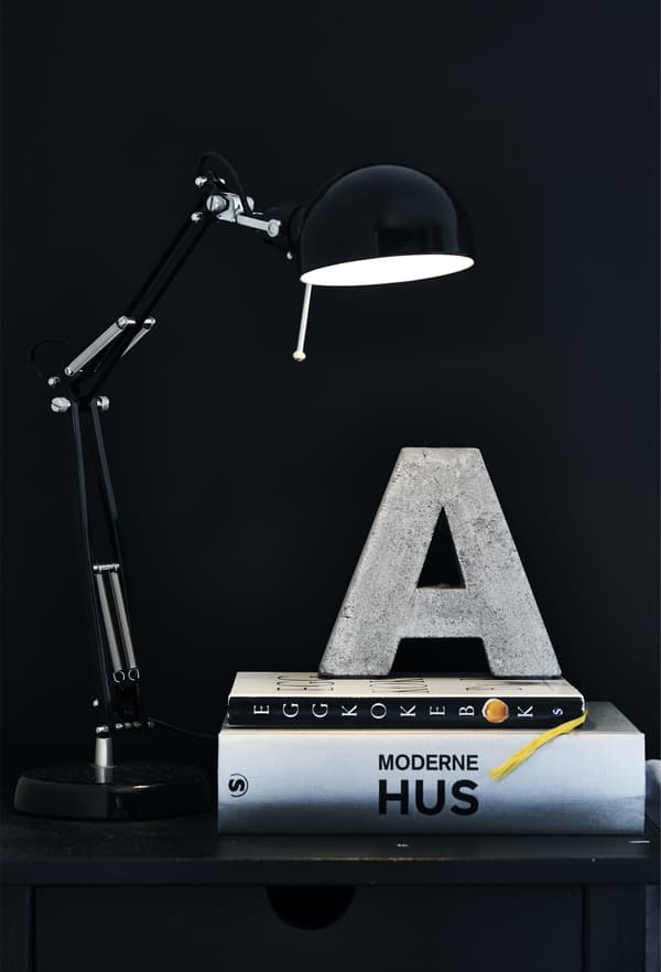 A black lamp and a stack of books.