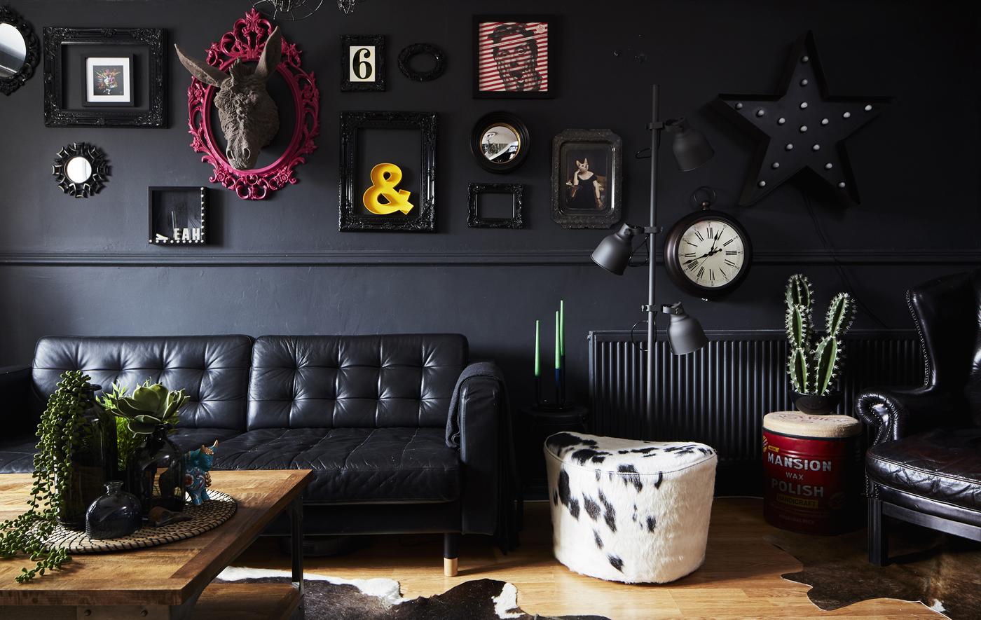 A black living room with cowhide footstool.