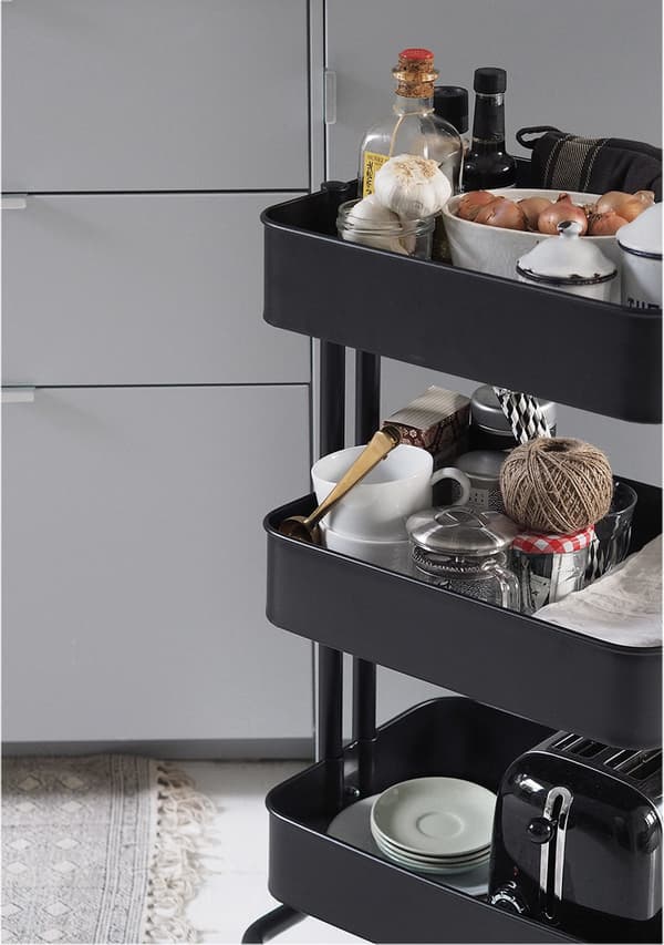 A black trolley with three storage shelves. 