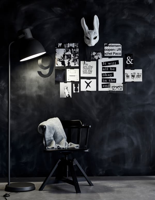 A black wall made into an inspiration board using removable tape.