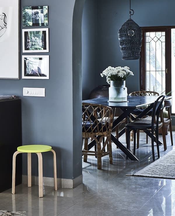 A blue dining area with new and vintage furniture.