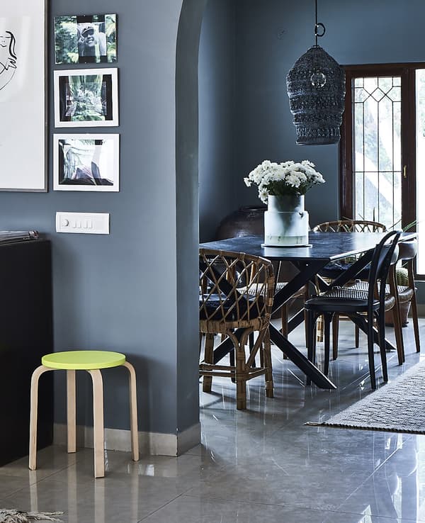 A blue dining area with new and vintage furniture.
