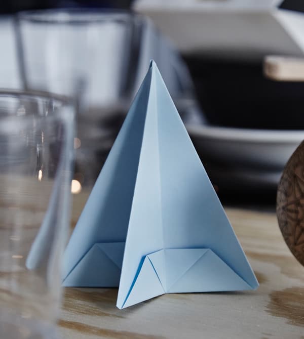 A blue origami Christmas tree.