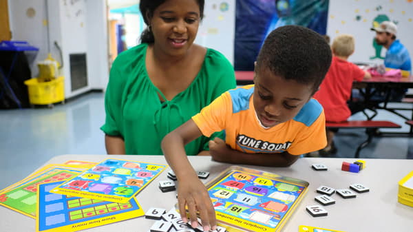 A boy and mother playing a game.