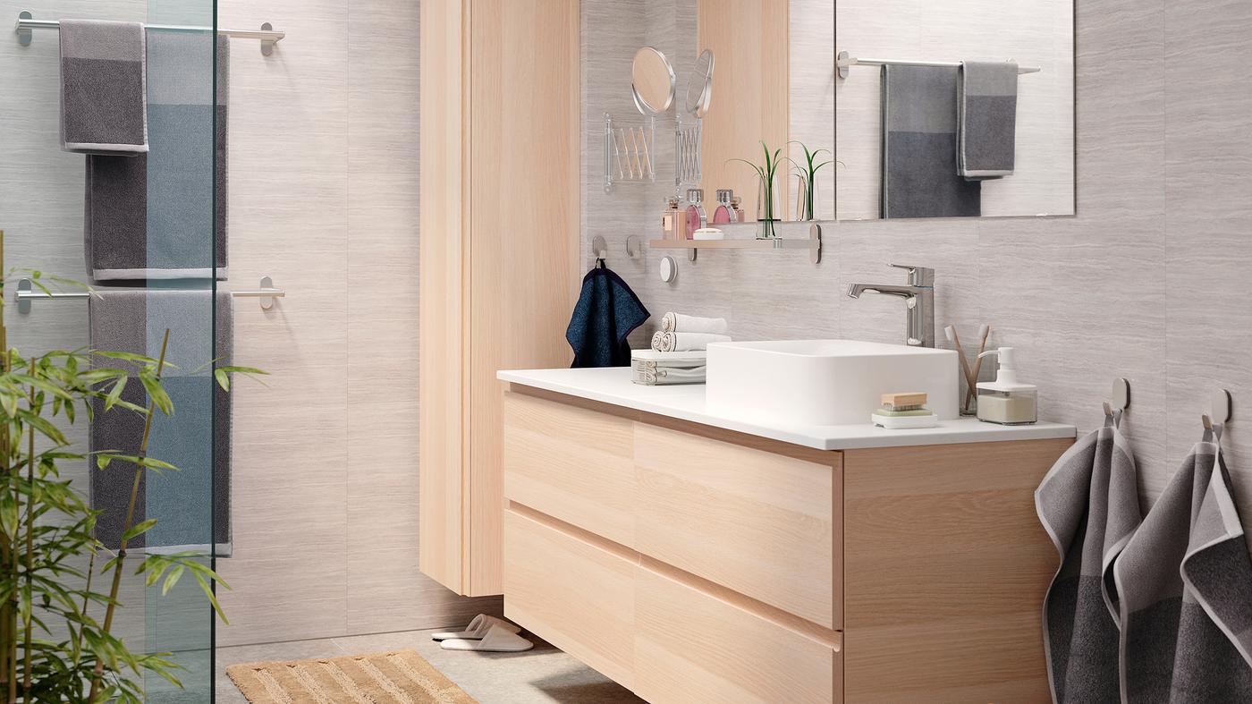 A bright and elegant bathroom with a GODMORGON wash-stand and GODMORGON high cabinet in white stained oak effect.