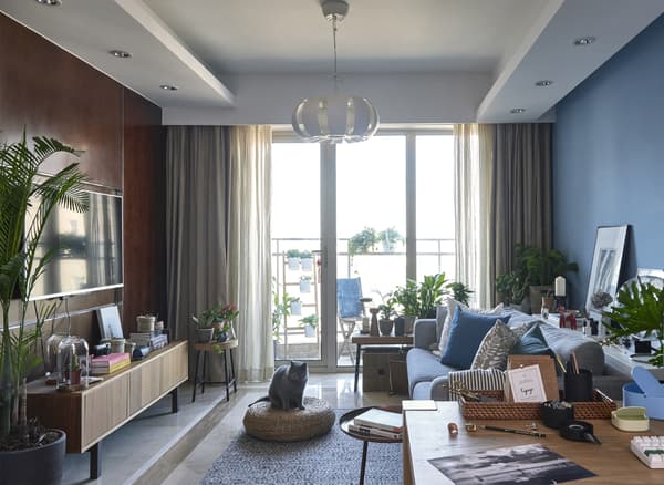 A bright living room in neutrals and blues.
