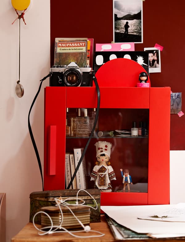 A bright red display box that shows off Lison's favorite tresures, including a doll, small books and nail polish.
