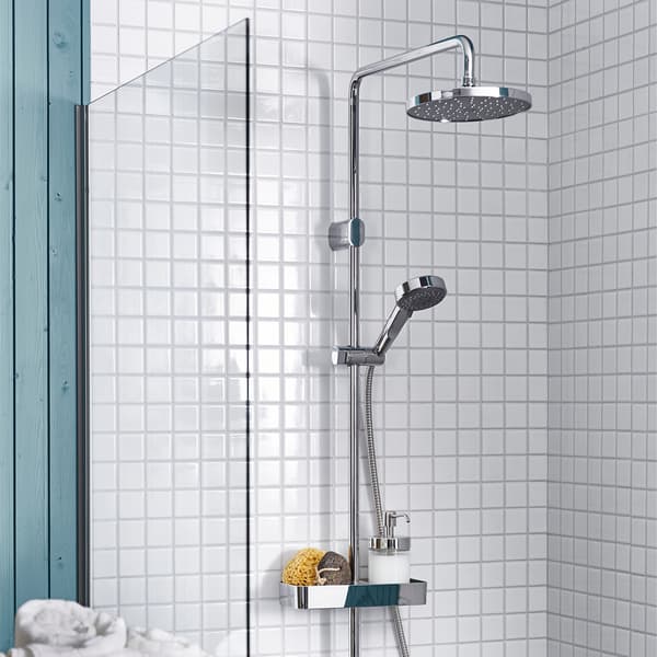 A BROGRUND shower in a white tiled bathroom with green details.