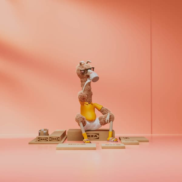 A cartoon hero sitting on top of an IKEA flat packs.
