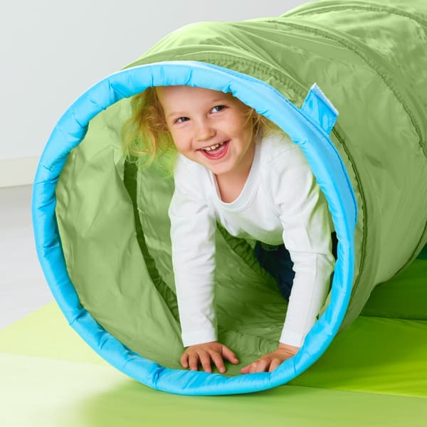 A child playing in a play tunnel.