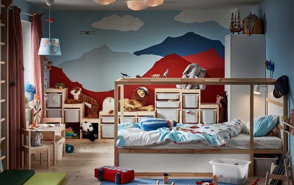 A child’s room visually dominated by a back wall with painted mountains. Reversible bed, wall bars, toys, various storage.