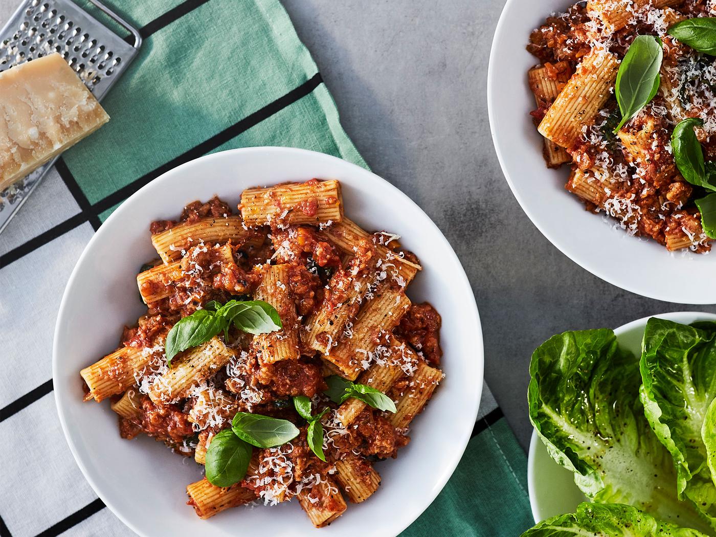 A classic Italian bolognese made from plant-based mince, served on white bowls.
