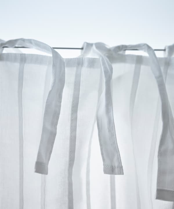 A close-up image of a curtain wire used to hang a canopy over a bed.