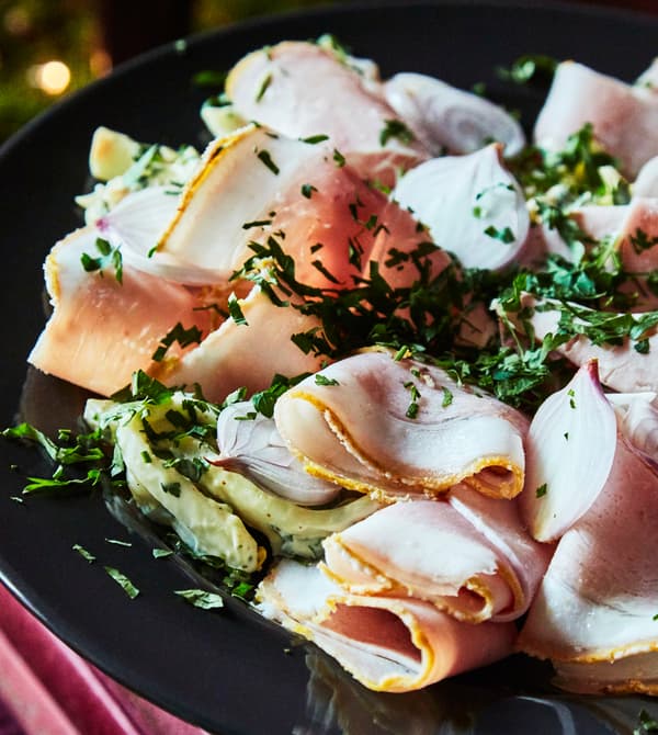 A close-up image of Christmas ham and celeriac remoulade.