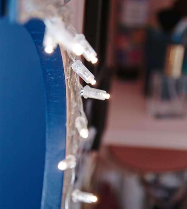 A close-up image of fairy lights hanging in the vanity cabinet.