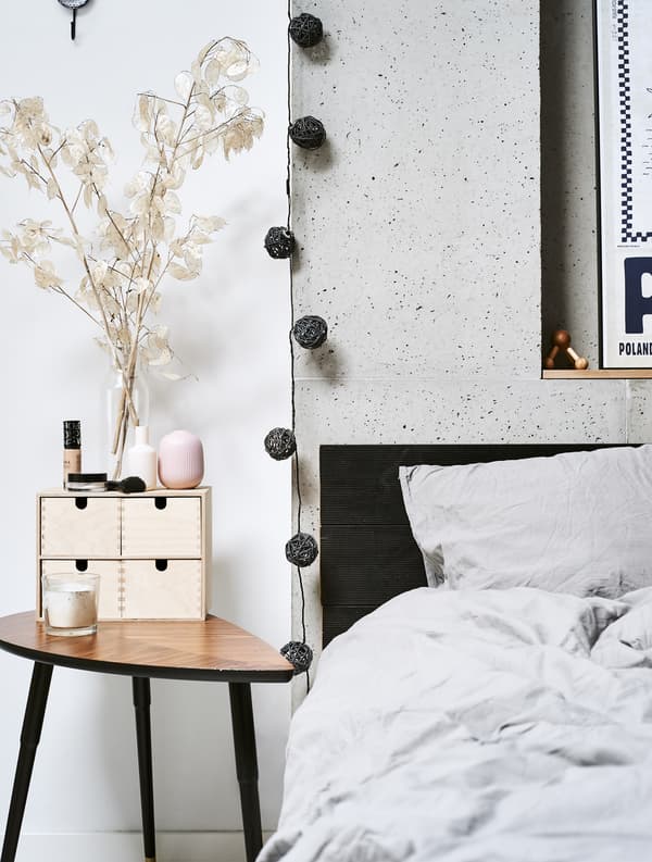 A close up of a bed and side table.