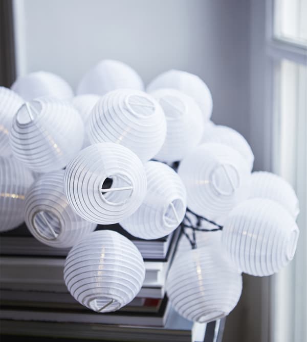 A close-up of a lighting chain of mini lanterns.