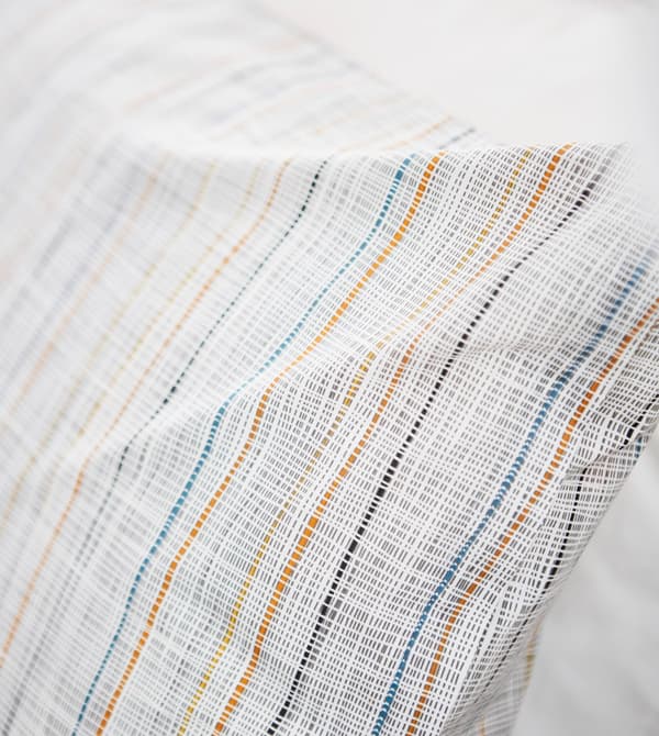 A close-up of a simple striped pillow.