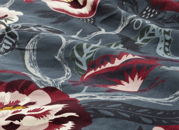A close-up of blue and red floral bedding.