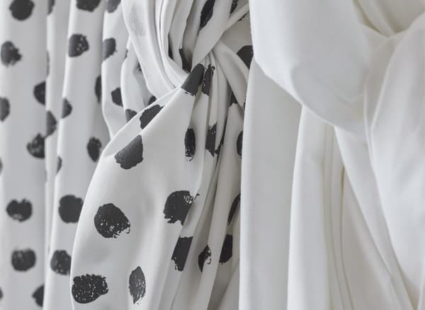 A close-up on patterned and plain fabric tied in plaits.