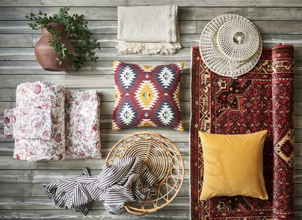 A collage of yellow and red textiles and decorative accessories.