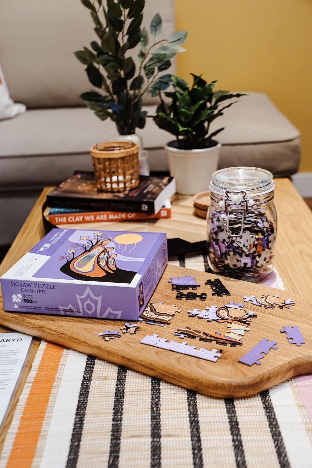 A collection of puzzle pieces and other home decor accessories sitting on a table.